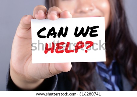 Businesswoman showing card with CAN WE HELP? message