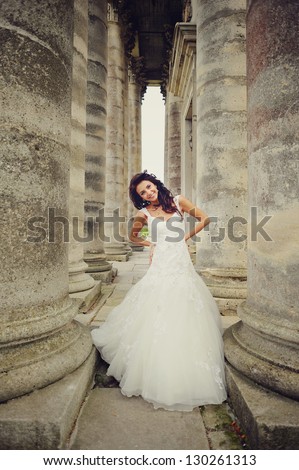 Beautiful bride posing on the steps of an old church in west Ukraine