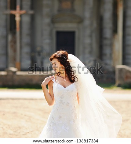 young bride next to old church