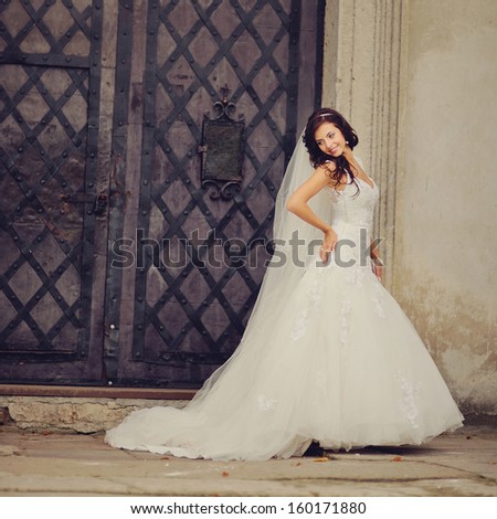 Beautiful bride posing on the steps of an old church