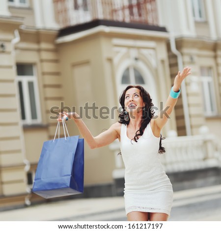 Its Time for shopping. Smiling woman at street.