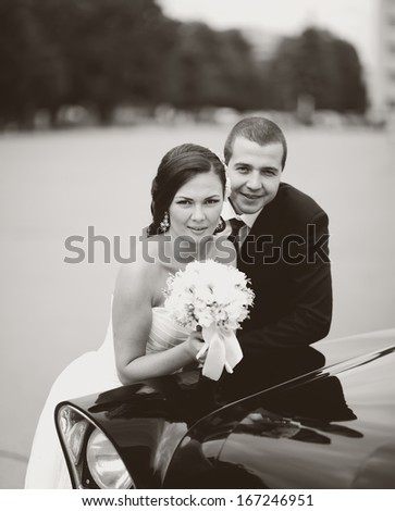 Young groom and bride at field. Wedding couple together in black and white.