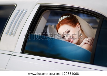 So happy and so glamorous. Lovely red hair bride in limo.
