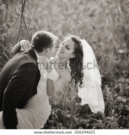 Loving newlywed couple outdoor. Bride and Groom at wedding Day.