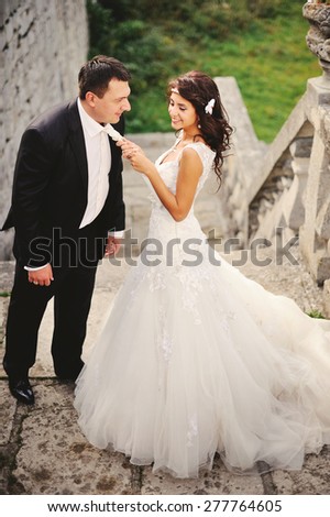 Happy bridal couple together. Summer wedding picture.