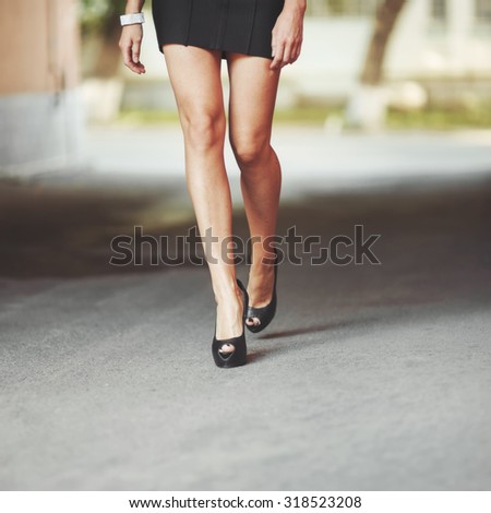 Young attractive legs of young pretty woman walking next to you.