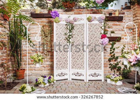Decorated photo zone for groom and bride and their guests. Bunch of flowers  gift. Colorful background.