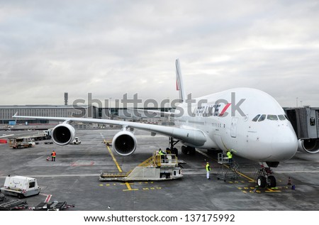 PARIS, FRANCE - JANUARY 22, 2012: Air France A380 connected to the passenger boarding bridge at Charles de Gaulle Airport. Air France is the French flag carrier headquartered in Tremblay-en-France.