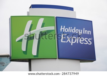 SLOUGH, UK - MAY 26, 2015: Logo of Holiday Inn Express Hotel. Holiday Inn Express is a mid-priced hotel chain within the InterContinental Hotels Group family of brands.