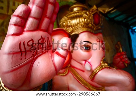 God Bless - symbolic gesture of Ganesha The idol of Ganesha molded using clay in real-life size, is painted and decorated by skilled artists / potters in the Pottery Village of Bangalore, India