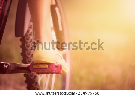Low viewing angle of woman leg on mountain bike pedal