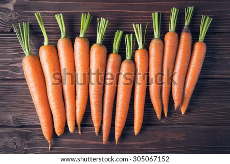 Raw carrot on old wooden background