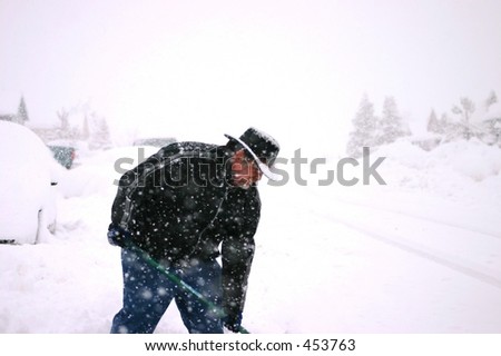 Man Shoveling Snow in Snow Storm