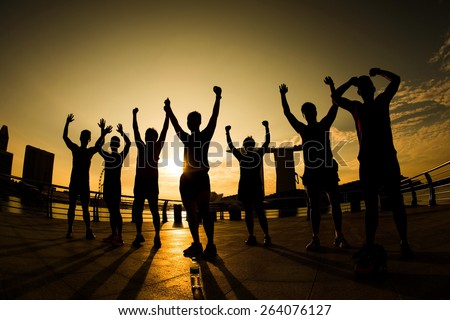 Singapore City March 14, 2015 Silhouette of Sport team hand up at Marina Bay Sunrise Time