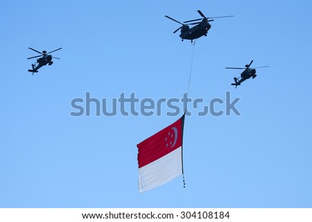 Singapore August, 1 2015: Chinook and Apaches Helicopter fly on sky for Fiftieth anniversary of Singapore 50 years National Day Golden Jubilee and big flag (Real day is Aug 9, 2015)