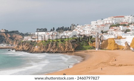 Similar – Image, Stock Photo Wide sandy Faro beach with dunes and walkways by the sunset, Algarve, Portugal