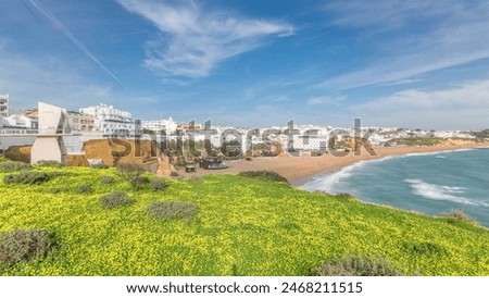 Similar – Image, Stock Photo Wide sandy Faro beach with dunes and walkways by the sunset, Algarve, Portugal