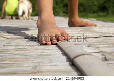 Child feet on bamboo floor.