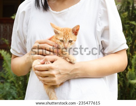 Women hugging kitten.