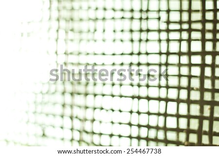 Blurred bamboo net filtered to green tone. Defocused photo.