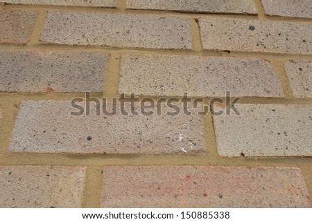 A brick wall on the side of a British house in Surrey.