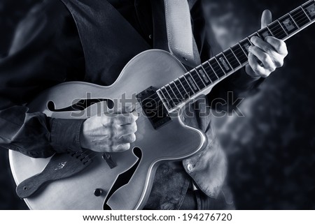 guitarist playing a custom made jazz guitar