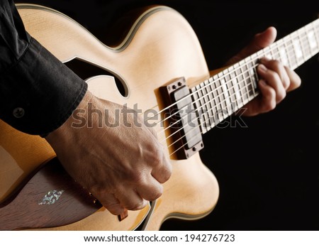 guitarist playing custom made jazz guitar