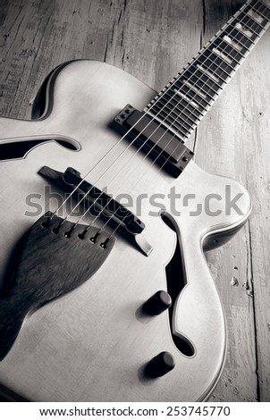 semi hollow jazz guitar on aged wood, vintage style photo