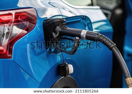 refueling Car fill with petrol gasoline at gas station and petrol pump filling fuel nozzle in fuel tank of car Foto d'archivio © 