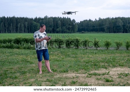 Similar – Foto Bild Fokussierter Mann steuert Drohne aus der Ferne