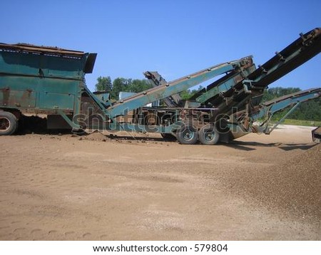 Loader and crusher on site at gravel pit