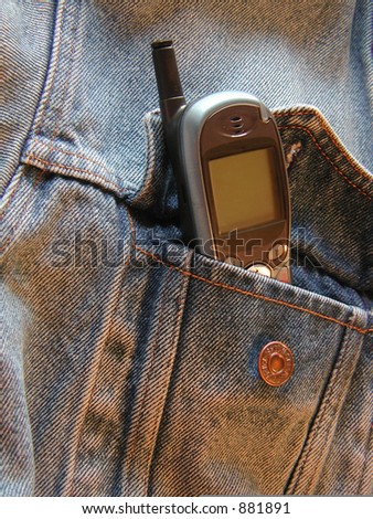cell phone sticking out of denim jacket pocket