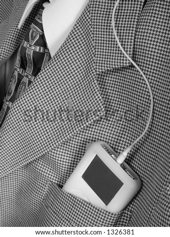 portable music player in business suit pocket