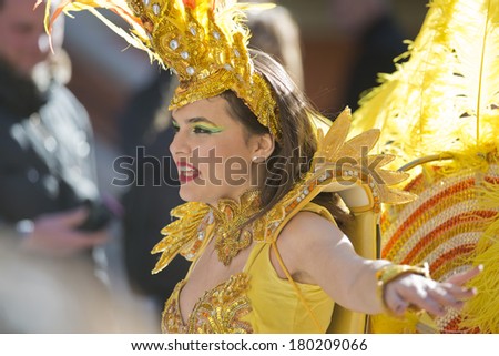 MENTON, FRANCE - 2 MARCH 2014 - Unidentified woman dressed as dancer marching during the parade of the Lemon Festival