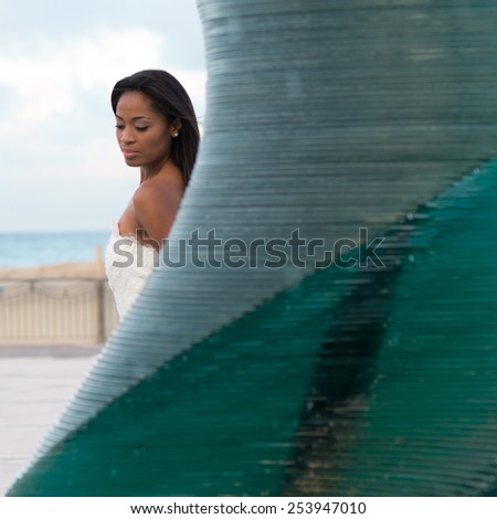 Brazilian model posing dressed like a bride near a fountain in Riccione