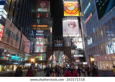 Osaka, Japan - February 2 , 2015 : Urban scene at night with many people around in Osaka , Japan