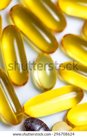 Fish oil and food supplement  pills macro vertical isolated on white background
