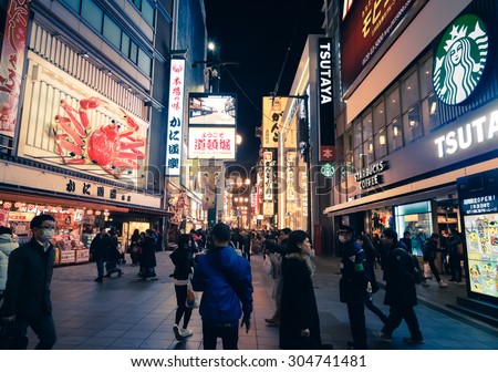 Osaka, Japan - February 2 , 2015 : Urban scene with retail service around Giant Crab restaurant area  at night in summer   with crowd people  around Kansai area  in Osaka , Japan