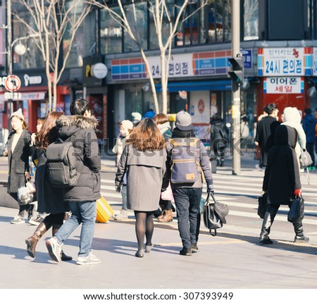 Seoul , South Korea - January 3, 2015 : People cross street at urban area in Seoul ,South Korea