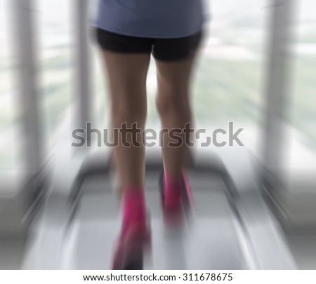 Radial Blur of Unknown woman running in gym like zoom burst motion blur
