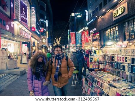 Seoul, Republic of Korea - January 1, 2015 :  People walk around shopping street with many store and service decorated with beautiful New Year light in Seoul, South Korea