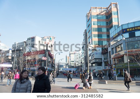 Seoul , South Korea - January 3, 2015 : People cross street at urban area in Seoul ,South Korea