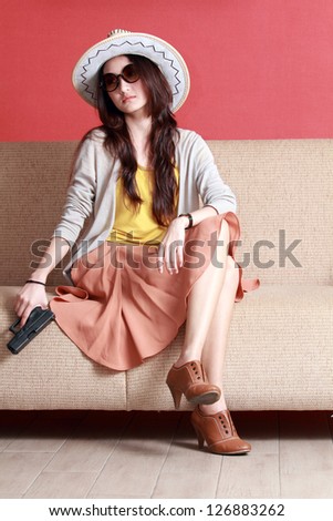 Young asian cute woman with semi-automatic pistol