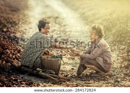 Sakon, Thailand - February 15 : Thai elderly sharing food on February 15, 2015 in Sakon, Thailand