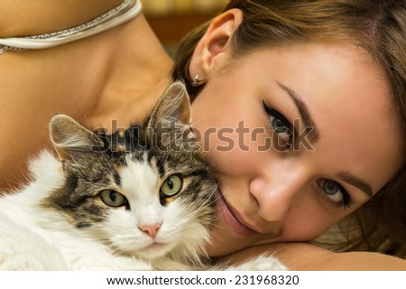 woman with cat on bed