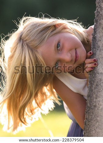 Portrait of blond little girl outdoors