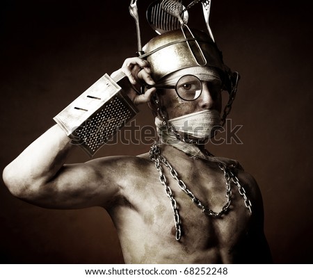 Strange man with pot on his head over dark background