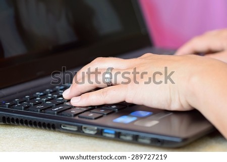 Close-up of typing female hands on keyboard.  Business woman hand typing on laptop keyboard.