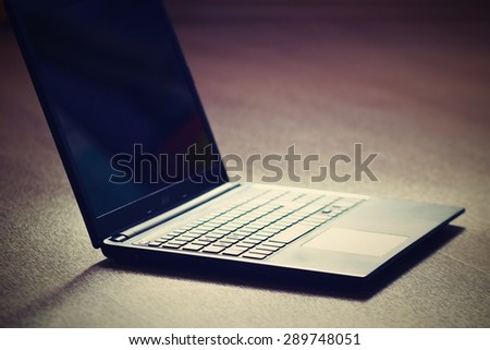 Technology and  business concept. Clean wooden background.\
Laptop computer.