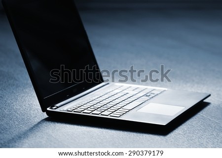Technology and  business concept. Clean wooden background. Laptop computer.